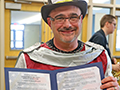  Kenmore East band teacher poses with legislative proclamation